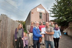 Members of the Abolish Empty Office Buildings campaign in St George, Bristol, agree the purchase of their first Empty Office, which the campaign will convert into affordable flats for people to live in as part of a new social housing co-operative in Bristol. Left to right: Elinor Kershaw, trustee, future resident and mum to Alice Kershaw (6); David Mowat, adviser; Tony Crofts, founder and trustee; James Deane, future resident; vendor Jason Fuller; Chris Askew and Nerea Gonzalez, architects.