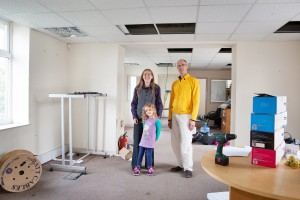 Members of the residents' group of the Abolish Empty Office Buildings campaign, Alice Kershaw (6) Elinor Kershaw and James Deane, take a look at the first office property the group is going to buy in St George, Bristol, for conversion to a social housing co-operative.